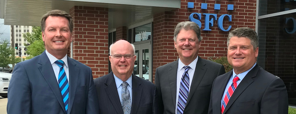 From left, SFC Bank CEO Rob Fulp poses with Jim Anderson, Larry Lipscomb and Monte McNew, president and board member of the company.